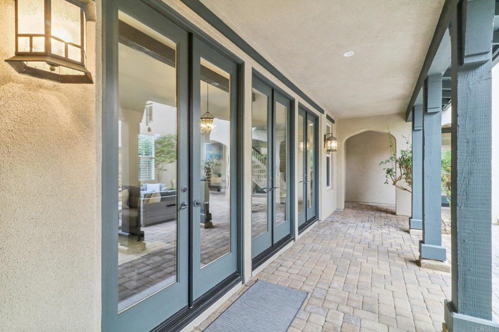 7618 Circulo Sequoia Carlsbad, CA 92009 - Photo 18 of 45 a view of a hallway with wooden floor and a living room