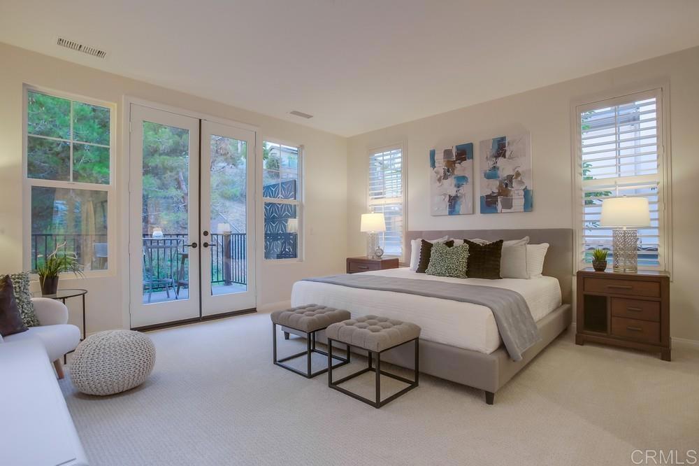 7618 Circulo Sequoia Carlsbad, CA 92009 - Photo 21 of 45 a spacious bedroom with a bed and glass walk in closet