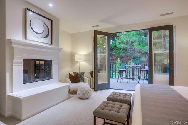 a bedroom with furniture and a fireplace