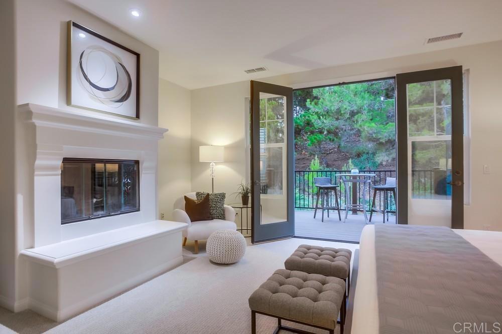 7618 Circulo Sequoia Carlsbad, CA 92009 - Photo 24 of 45 a bedroom with furniture and a fireplace