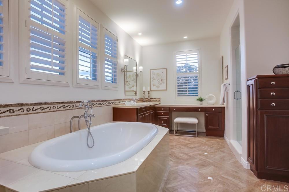 7618 Circulo Sequoia Carlsbad, CA 92009 - Photo 27 of 45 a kitchen with a sink dining table and chairs