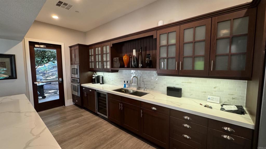 7618 Circulo Sequoia Carlsbad, CA 92009 - Photo 42 of 45 a kitchen with a sink stove and cabinets