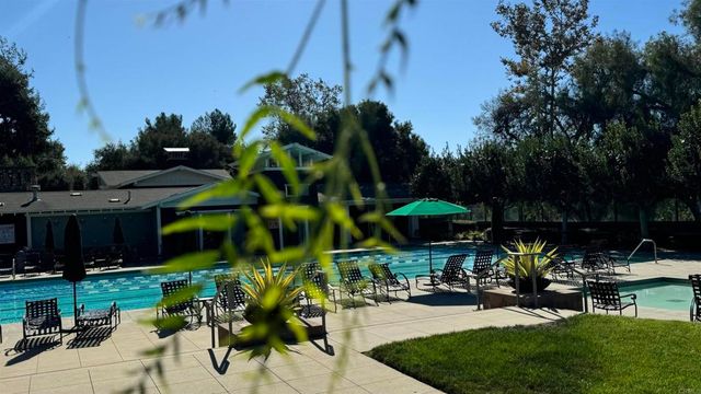 an aerial view of a house with a yard basket ball court and outdoor seating