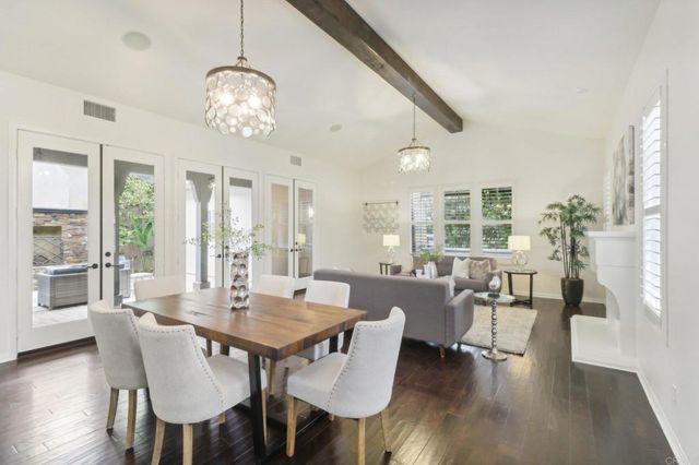 a view of a dining room with furniture wooden floor and chandelier