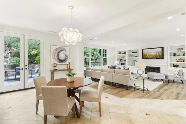 a living room with fireplace furniture and a chandelier