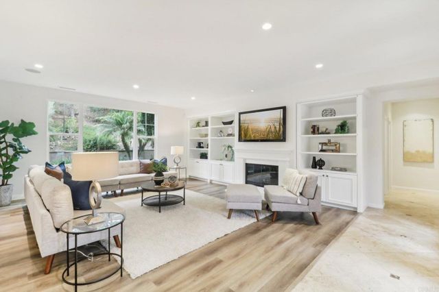 a living room with fireplace furniture and a flat screen tv