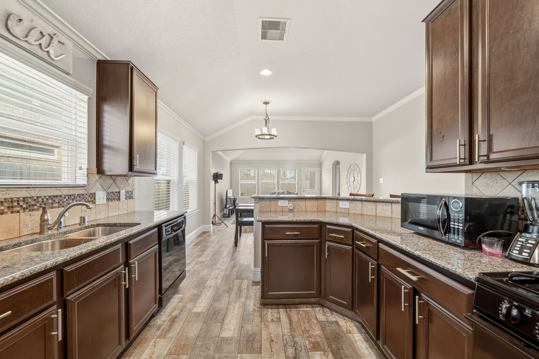 29446 Ridge Clearing Trail Spring, TX 77386 - Photo 12 of 28 Open kitchen design with granite counters and rich cabinets overlooking the main living area.