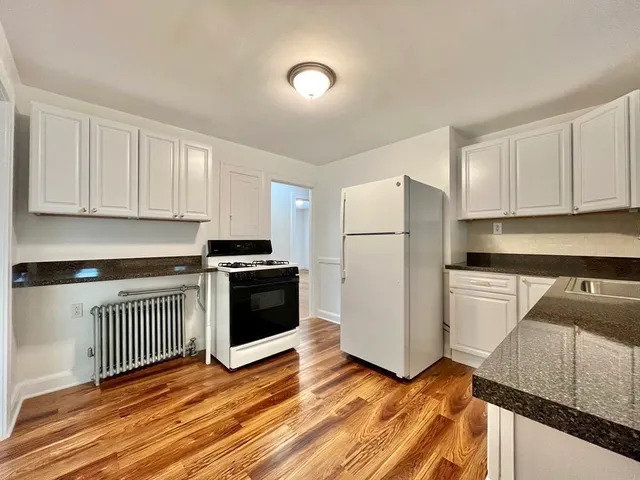 a kitchen with sink cabinets and stainless steel appliances