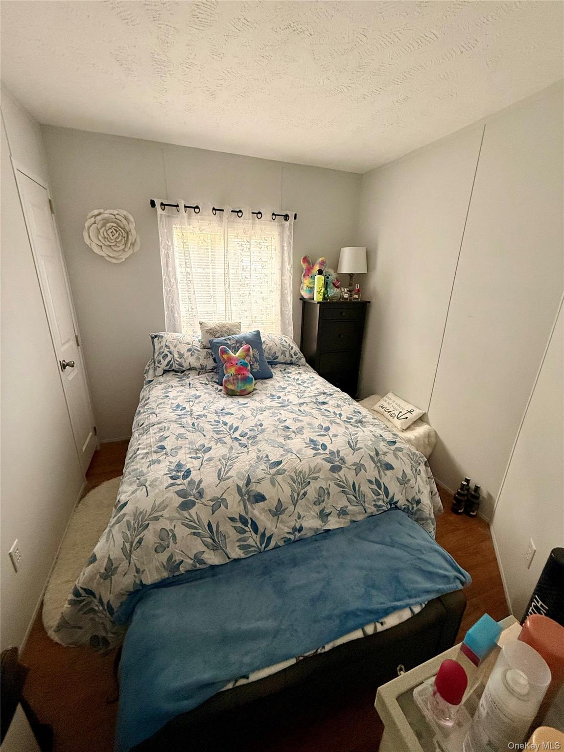 37 Hubbard Avenue, Unit 95 Riverhead, NY 11901 - Photo 12 of 14 Bedroom featuring a textured ceiling