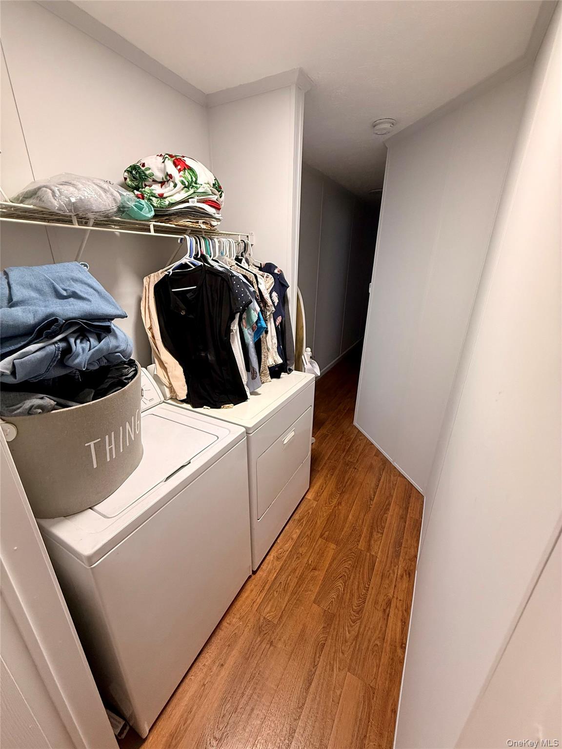 37 Hubbard Avenue, Unit 95 Riverhead, NY 11901 - Photo 14 of 14 Laundry area featuring light wood-style flooring and washing machine and dryer