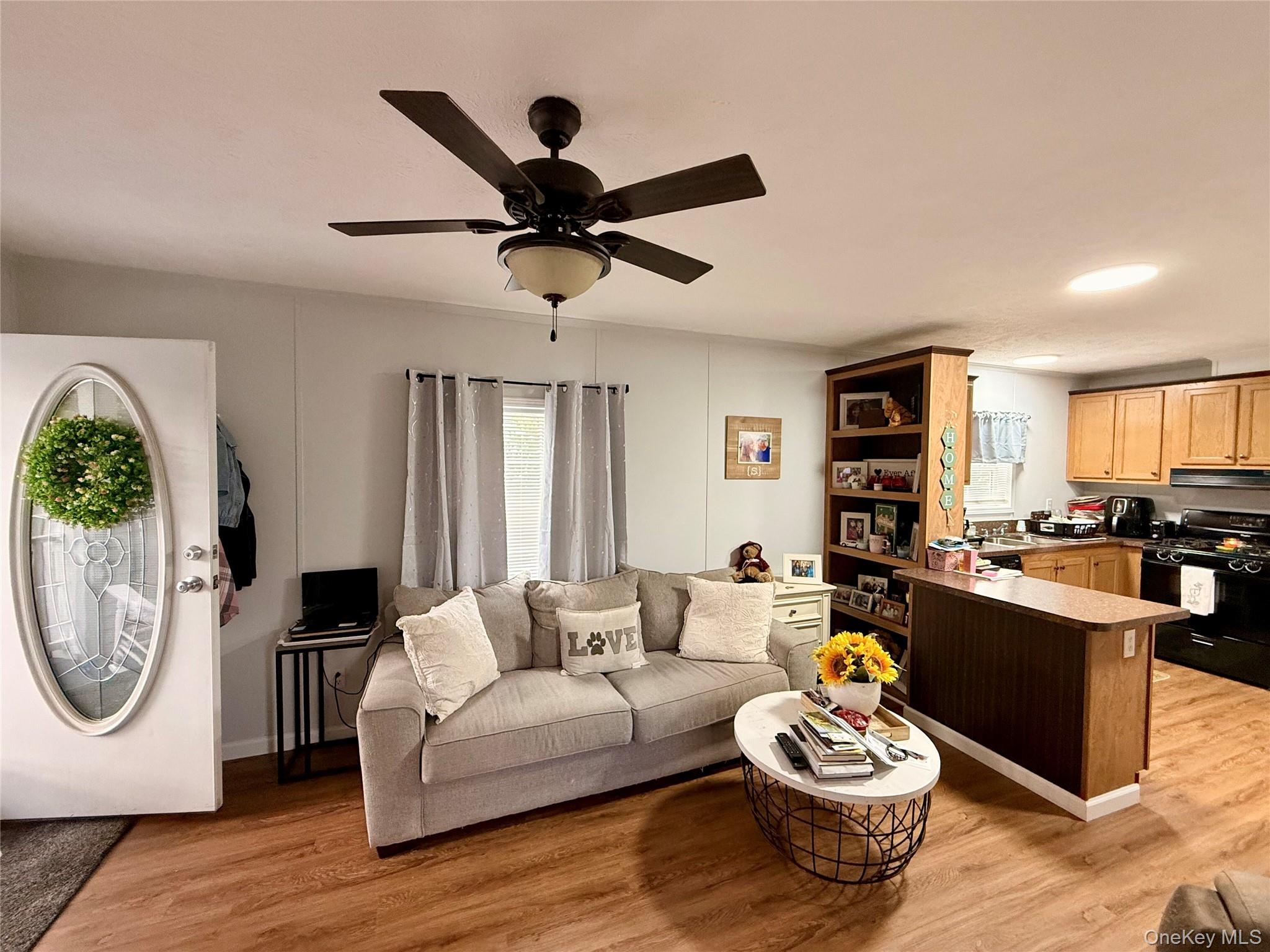 37 Hubbard Avenue, Unit 95 Riverhead, NY 11901 - Photo 5 of 14 Living area featuring light wood finished floors, ceiling fan, and recessed lighting