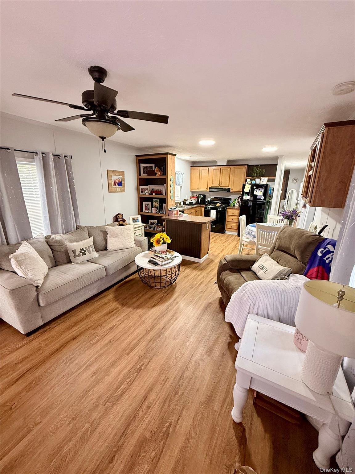 37 Hubbard Avenue, Unit 95 Riverhead, NY 11901 - Photo 7 of 14 Living room with light wood-style floors and ceiling fan