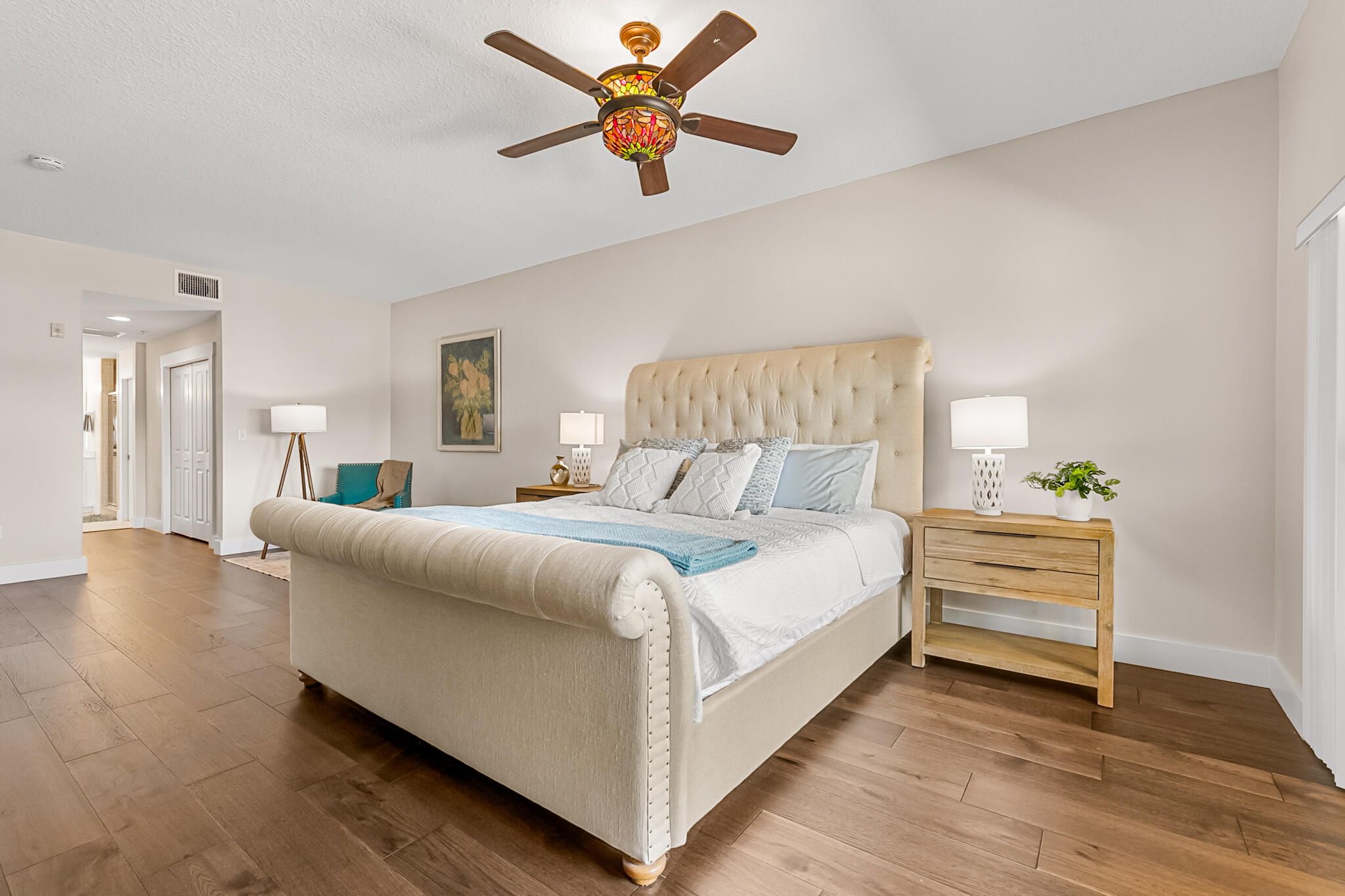 29 Riverside Drive, Unit 201 Cocoa, FL 32922 - Photo 18 of 46 a bedroom with a bed and a ceiling fan