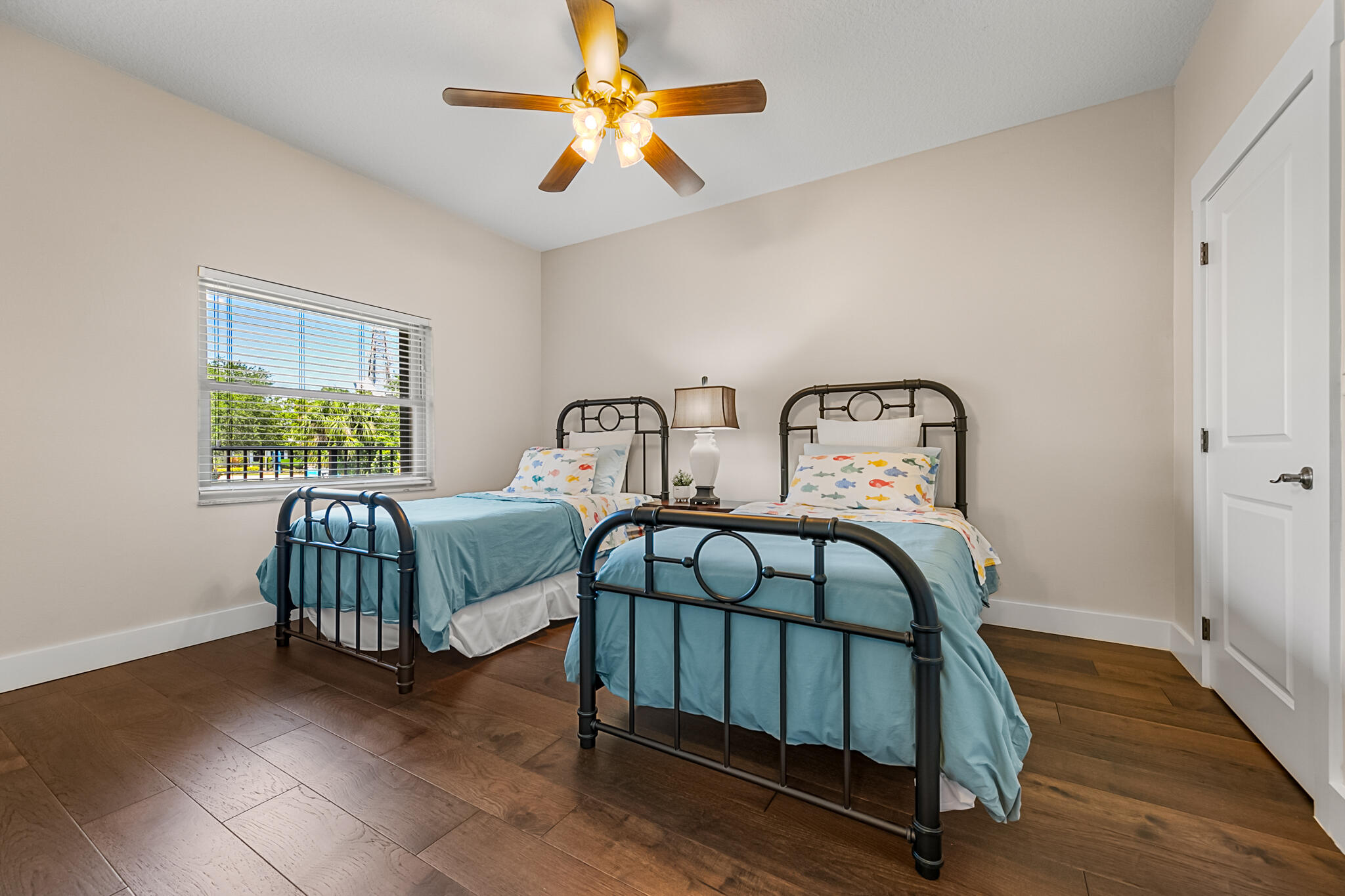 29 Riverside Drive, Unit 201 Cocoa, FL 32922 - Photo 8 of 46 a bedroom with two beds and wooden floor