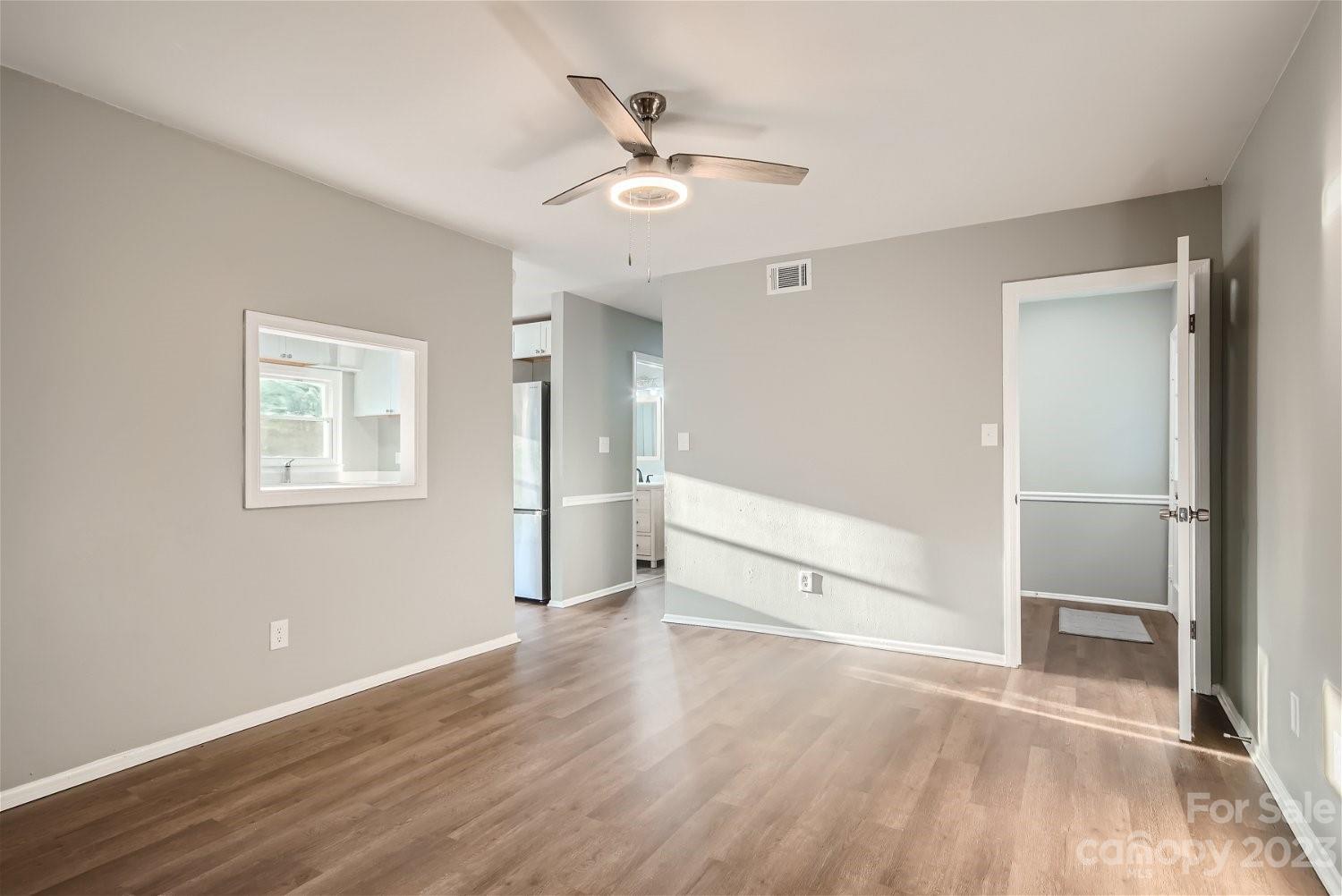 7438 Bramblewood Drive Charlotte, NC 28217 - Photo 13 of 27 wooden floor in an empty room with a window