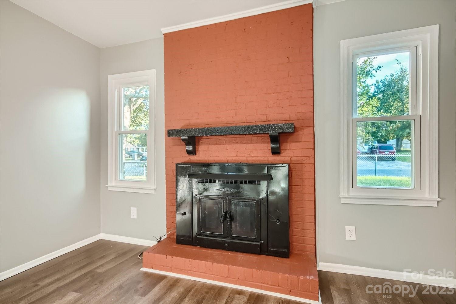 7438 Bramblewood Drive Charlotte, NC 28217 - Photo 15 of 27 an empty room with fireplace and windows