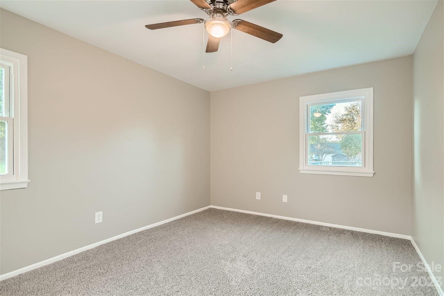 7438 Bramblewood Drive Charlotte, NC 28217 - Photo 16 of 27 an empty room with a window and a fan