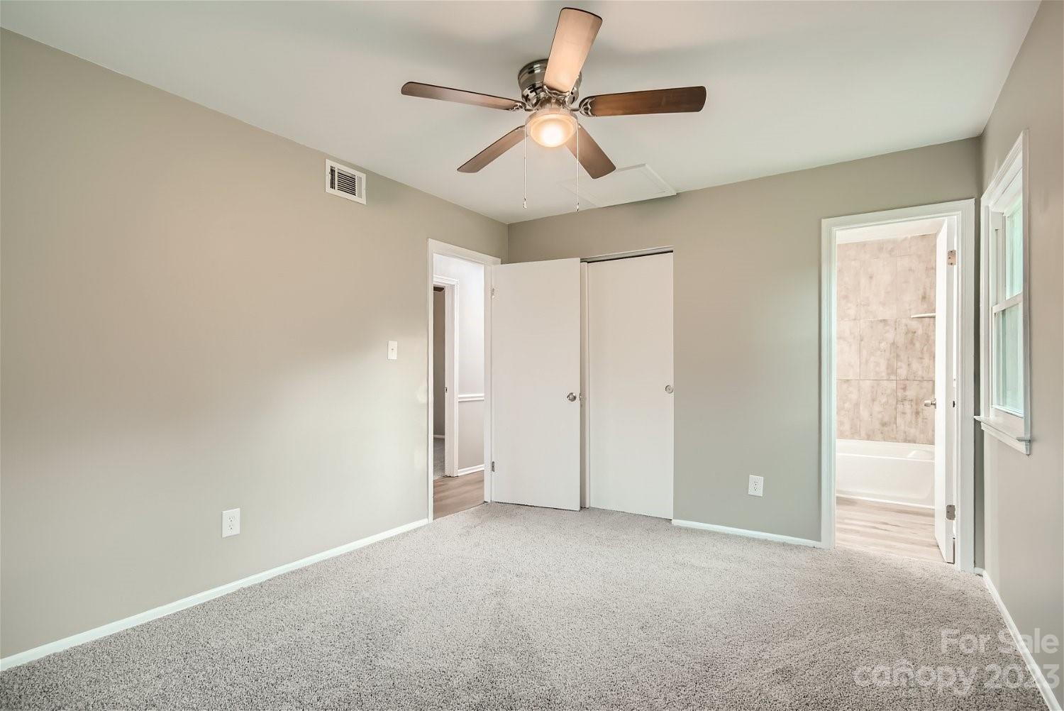 7438 Bramblewood Drive Charlotte, NC 28217 - Photo 18 of 27 a view of an empty room and a ceiling fan