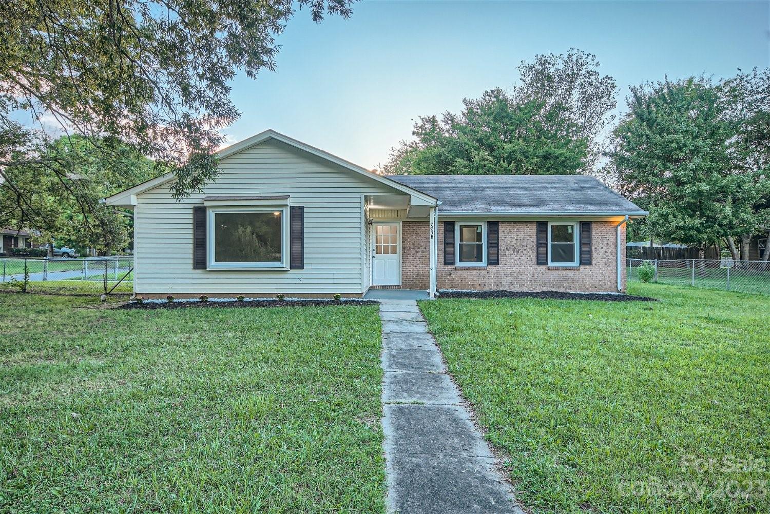 7438 Bramblewood Drive Charlotte, NC 28217 - Photo 2 of 27 a front view of a house with yard