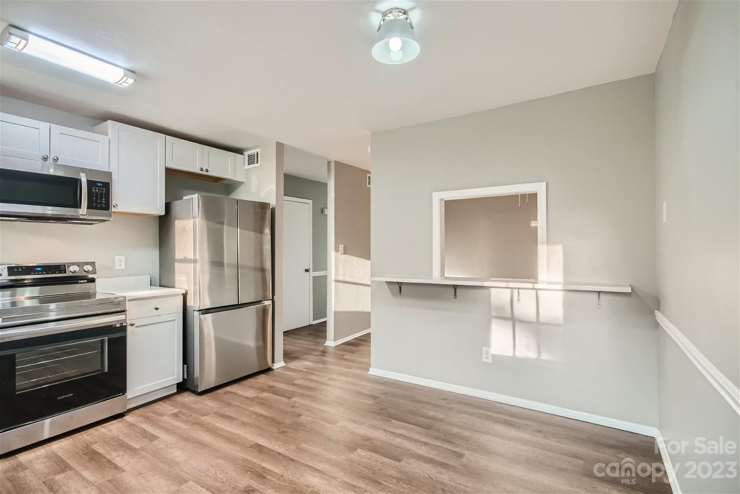 7438 Bramblewood Drive Charlotte, NC 28217 - Photo 24 of 27 a kitchen with stainless steel appliances a refrigerator stove and microwave