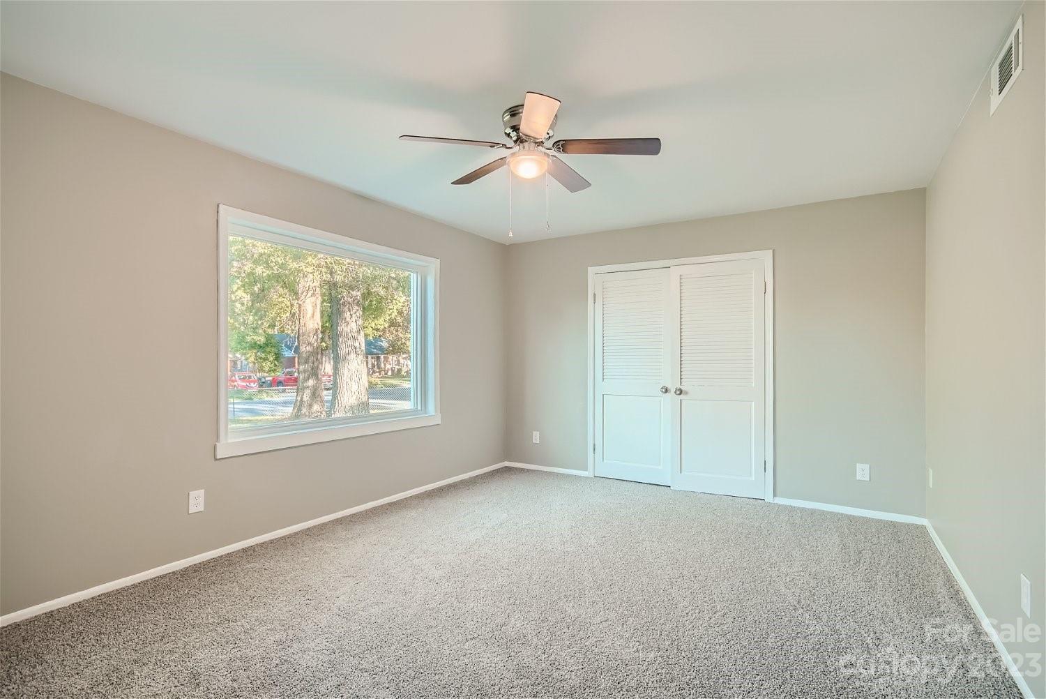 7438 Bramblewood Drive Charlotte, NC 28217 - Photo 5 of 27 an empty room with windows and fan
