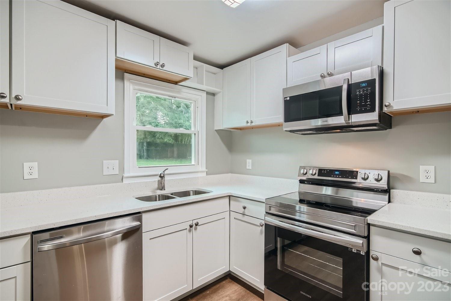7438 Bramblewood Drive Charlotte, NC 28217 - Photo 9 of 27 a kitchen with stainless steel appliances white cabinets and a sink