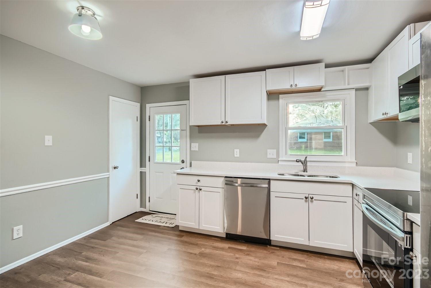 7438 Bramblewood Drive Charlotte, NC 28217 - Photo 10 of 27 a kitchen that has a sink and a stove in it