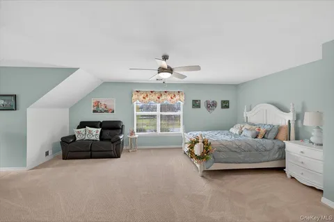 a living room with a bed furniture and a large window