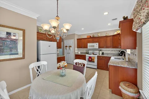 a living room with fireplace furniture and a chandelier