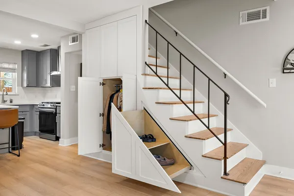 a view of entryway with kitchen and wooden floor