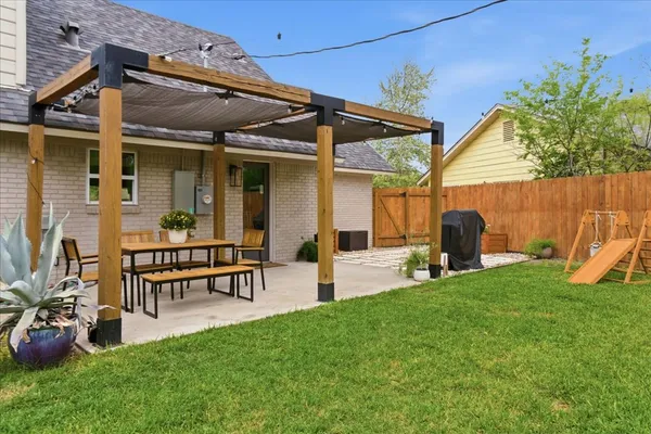 a view of a house with backyard sitting area and garden