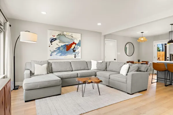 a living room with furniture and a painting