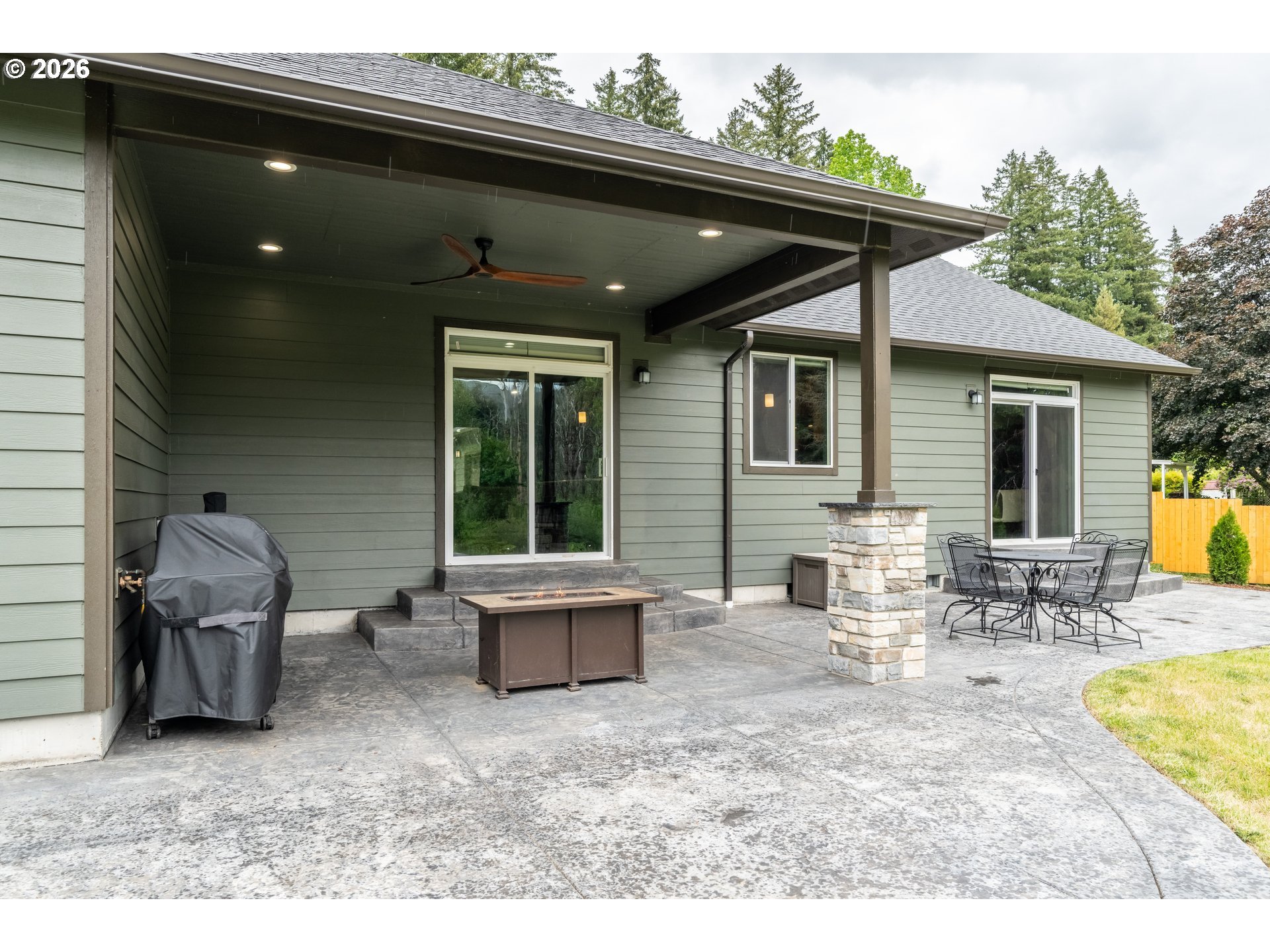 45542 South Gate Creek Road Vida, OR 97488 - Photo 45 of 46 a view of a patio with table and chairs wooden floor and a barbeque
