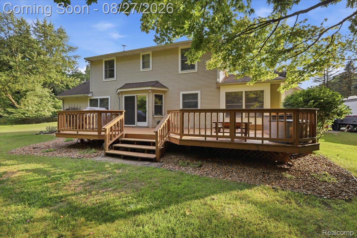10100 Springtime Circle Clarkston, MI 48348 - Photo 59 of 73 Expansive wooden deck with railing, dual-level construction, and multiple stair access points