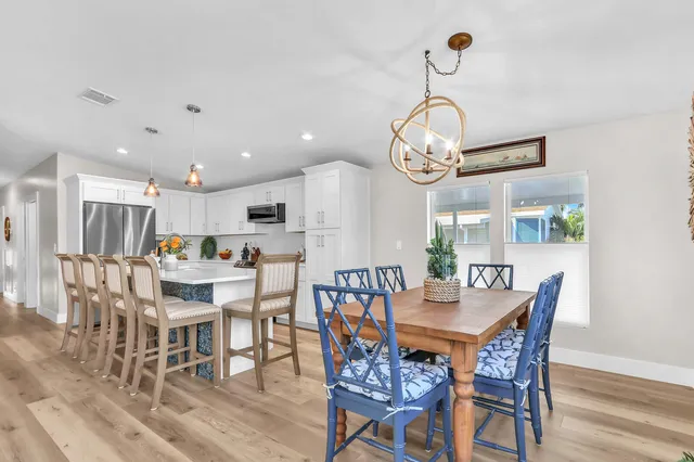a view of a dining room with furniture wooden floor and a chandelier