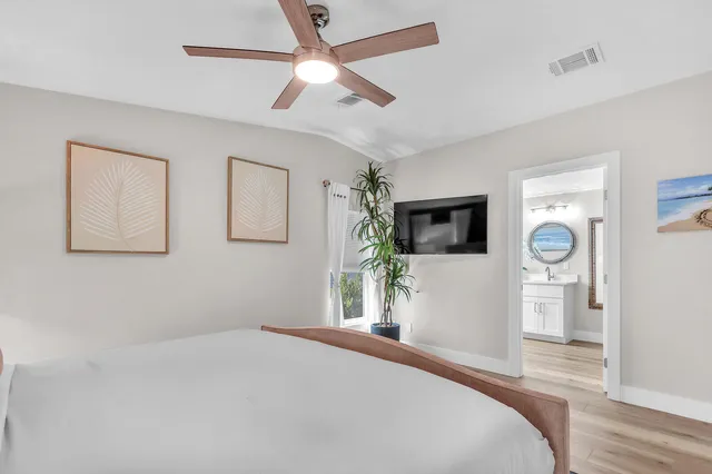 a bedroom with a bed and a flat screen tv