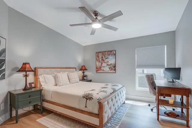 a bed room with a bed and a chair