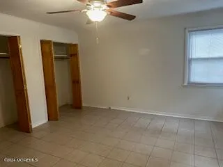 an empty room with chandelier fan