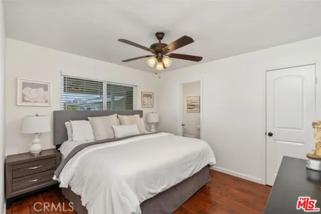 a bedroom with a bed and a ceiling fan