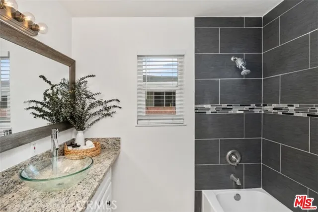 a bathroom with a potted plant and a sink