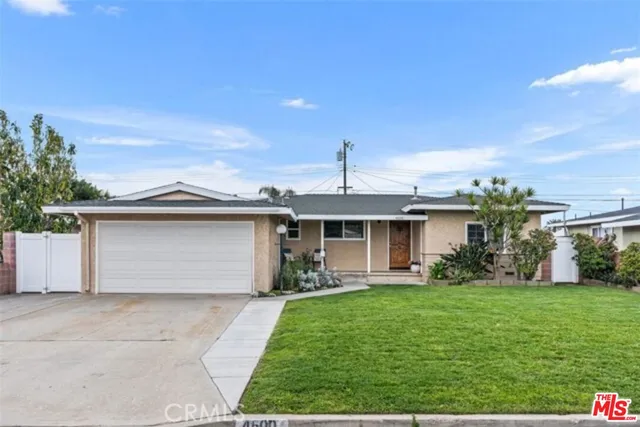 a front view of house with a garden