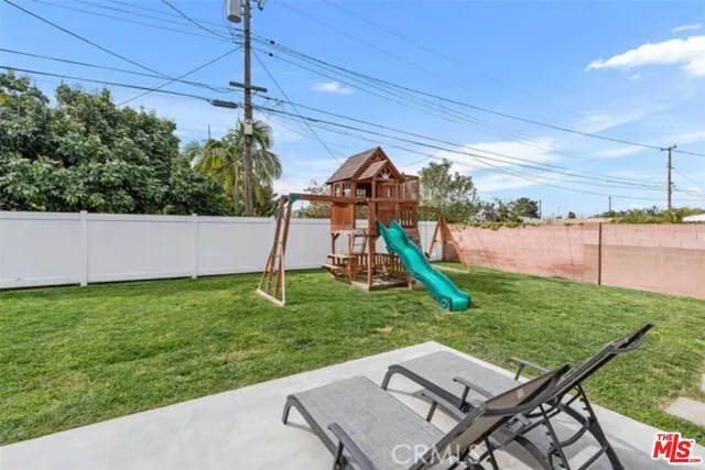 a view of a backyard with plants and a garden