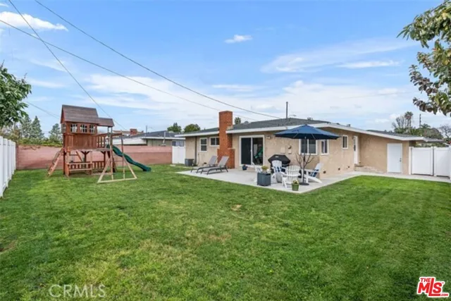 a view of a house with a yard and sitting area