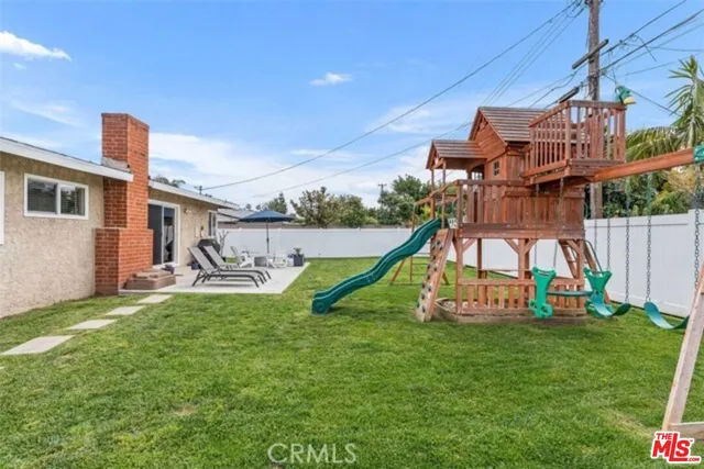 a view of a house with backyard and a slide
