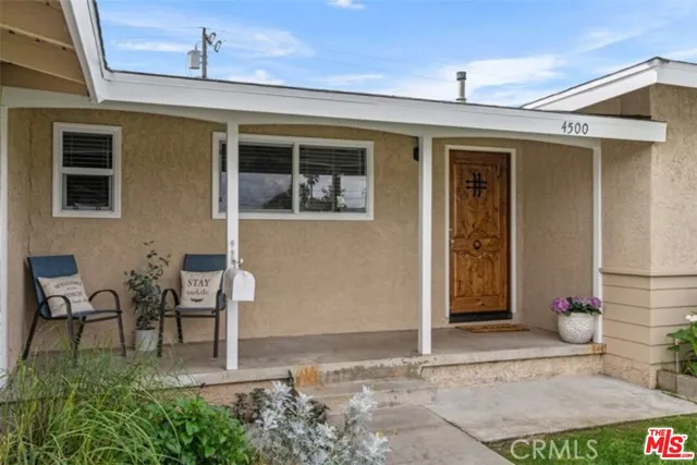 a view of a patio with table and chairs and potted plants