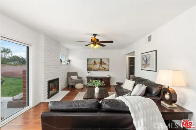 a living room with furniture a fireplace and a potted plant