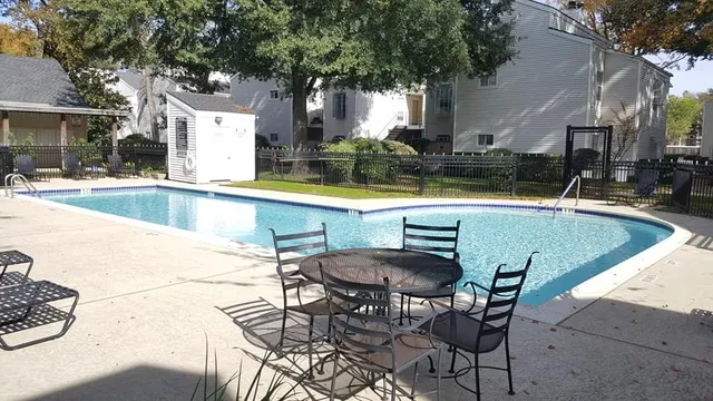 a swimming pool with outdoor seating and yard
