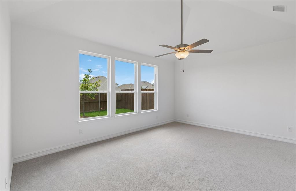 11220 Abbotsbury Road Fort Worth, TX 76052 - Photo 9 of 32 an empty room with windows and fan