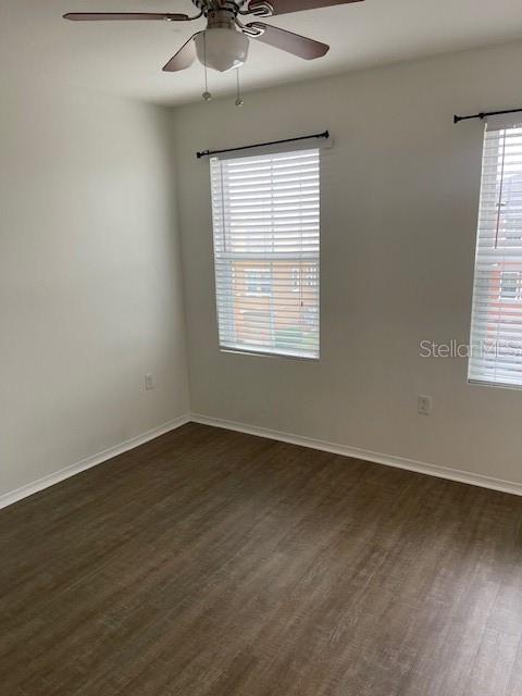 8893 White Sage Loop Lakewood Ranch, FL 34202 - Photo 12 of 14 an empty room with wooden floor and windows