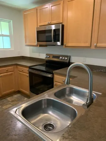 a kitchen with a sink and a microwave